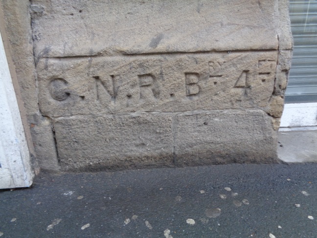 Close-up of the G.N.R. Boundary marker at the former Wellesley Hotel on Wellington Street (taken Dec 10 2015).