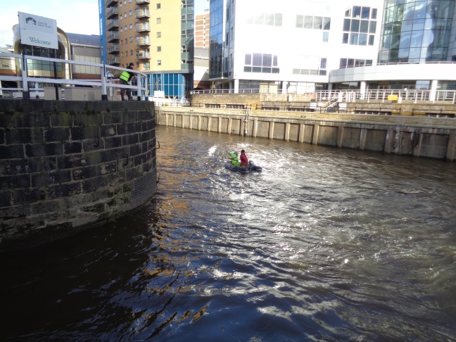 View of some men on the River Aire presumably doing work related to the flood defence scheme where the river joins the Leeds Liverpool Canal (taken Jan 28 2016).