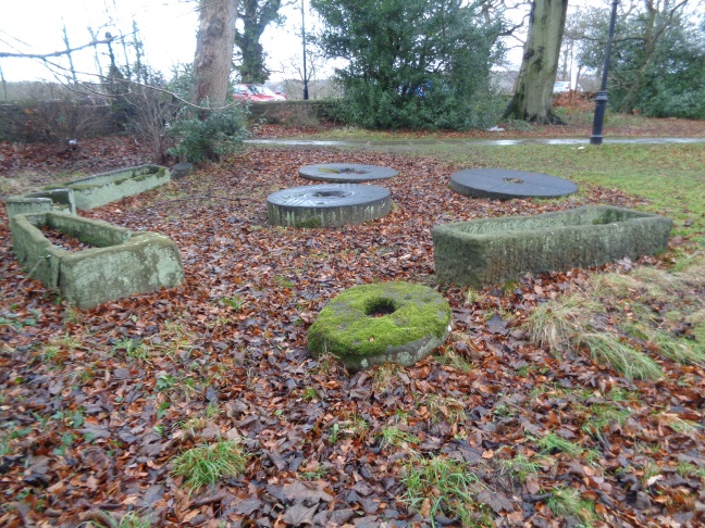 Old stone coffins or troughs and grindstones at St John the Baptist Church, Adel, Leeds. Jan 01 2017..jpg